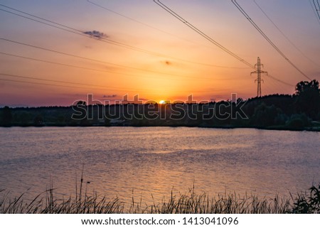 Sunset over the lake. Beautiful summer landscape.