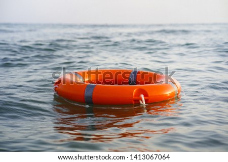 Red lifebuoy in sea on water.  Royalty-Free Stock Photo #1413067064