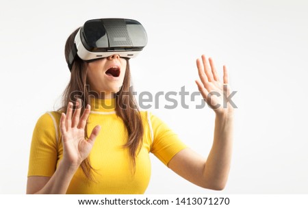 Young woman wearing virtual reality device over white background. 
Virtual Reality digital concept touch screen.
