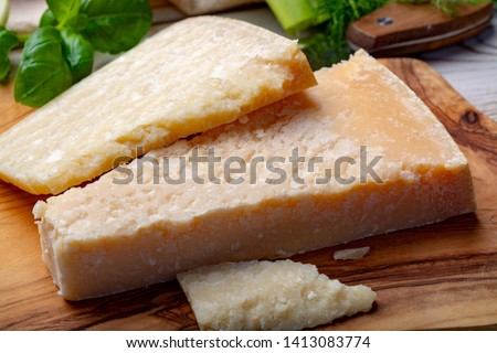 Original italian cheese, aged Parmesan cow milk cheese, pieces of Parmigiano-Reggiano close up