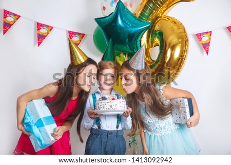 Children blowing birthday candles. Children birthday party