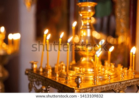 Large candlestick with burning candles in   church. 