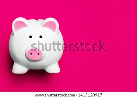 White piggy bank isolated on pink. Money saving background. Empty copy space business backdrop.