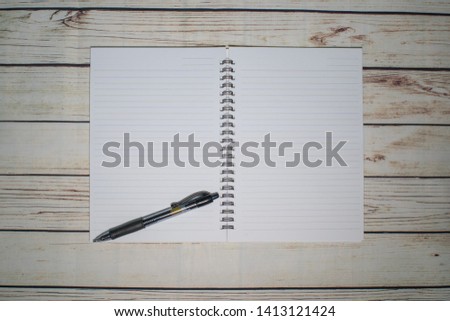 Pen and blank note paper on vintage wooden table.Background concept with copy space.