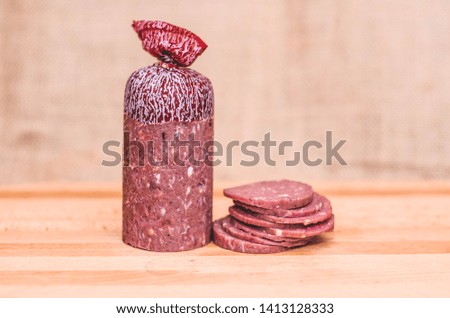 sausage of beef in the burgundy shell is made according to the technology of sous view