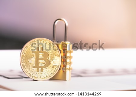Bitcoin(BTC) coin with padlock lying on computer background. Bitcoin security. digital cyber safety or security encryption, Blockchain technology to encode online information or data protection.  Royalty-Free Stock Photo #1413144269