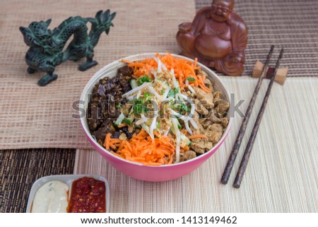 Vietnamese food: Bo Bun Tofu with chicken and carrots, served with asian decoration.