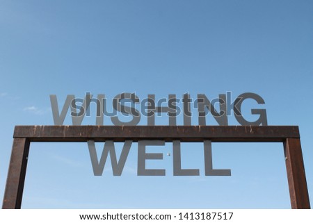 Wishing Well sign on square entrance