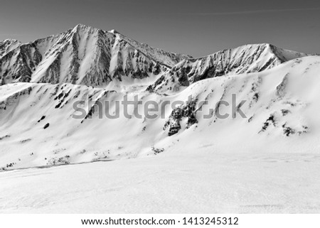 Black and white photo of Beautiful high altitude alpine landscape with snow capped peaks, Rocky Mountains, Colorado