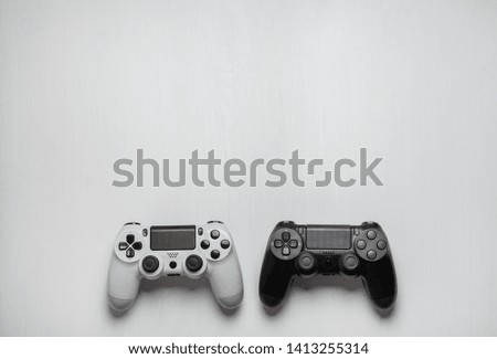 black and white modern gamepad on white wooden background