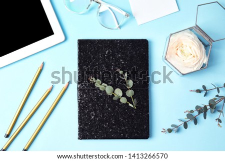 Blogger's workplace with notebook, tablet and flower on color background, flat lay