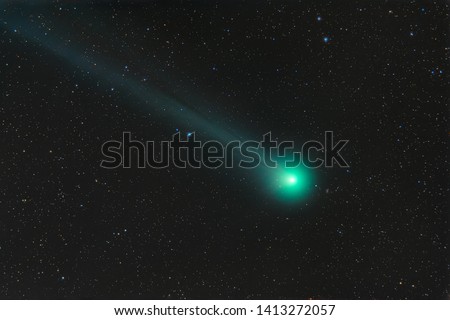 Photo of a real comet. Comet C 2014 Q2 LOVEIOY. Outer space with a flying comet. Natural background.