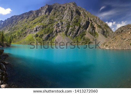 Blue lake in the mountains. Mountain and mountain lake.