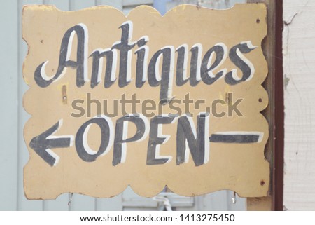 Weathered Antiques Open sign with arrow pointing