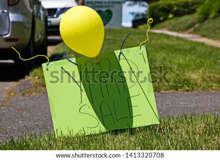 Bright green yard sale in front of a house