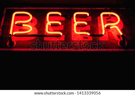 Gritty Vintage Neon Sign That Says Beer isolated with Glow on Black Negative space