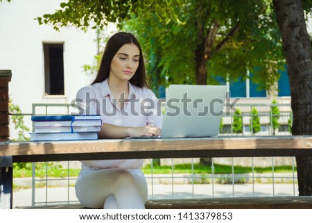 Young woman working on laptop. Student work process concept.Concentrated at work