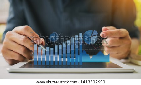Businessman investment consultant analyzing company financial report balance statement working with digital augmented reality graphics. Concept for business, economy and marketing. 3D illustration. Royalty-Free Stock Photo #1413392699