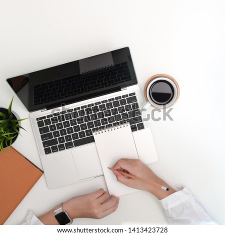 Woman working on her laptop in modern office.