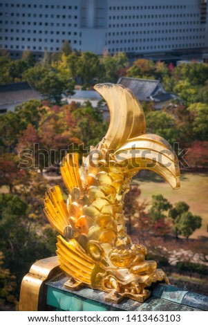 Golden Shachi-roof ornaments at Osaka Castle in Japan, exquisite sculptural details inspired by a mythical creature with a head of a tiger and body of a carp, which role is as protector of the castle.