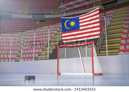 Flag of Malaysia in hockey arena with puck and net