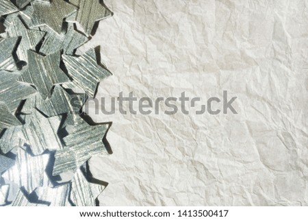 
crumpled white paper background with silver stars