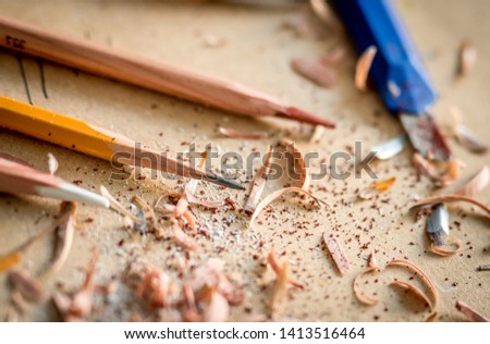 Close-up of graphite graphic pencils with wooden chips, soft focus
