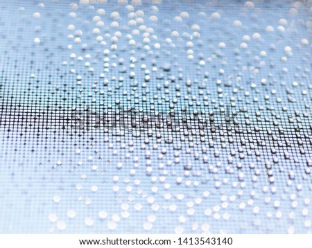 closeup wire screen and water drops with water bokeh 