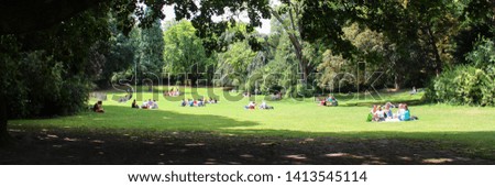 
Public park with people resting Royalty-Free Stock Photo #1413545114