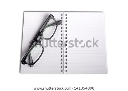 Open empty notebook with lined pages and eyeglass.