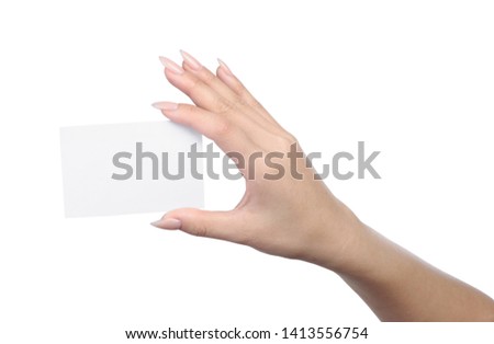 Empty sheet of paper in female hand with manicure isolated on white