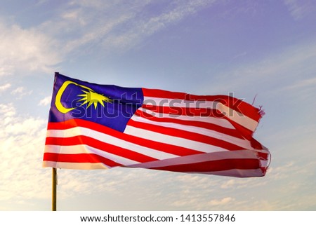 Malaysia flag waving during morning sunrise with sky background