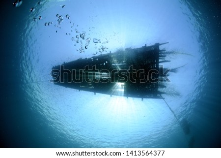 Fishing platform-raft on the ocean surface, the view from under the water. Underwater wide angle photography. Underwater background. Tulamben, Bali, Indonesia. 