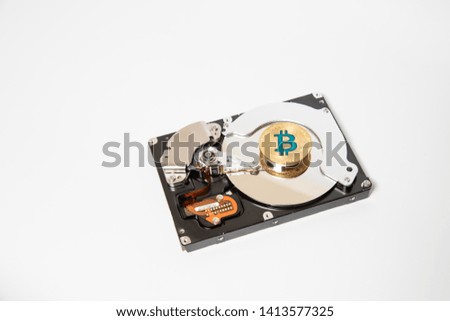 Golden bitcoin on hard drive disk