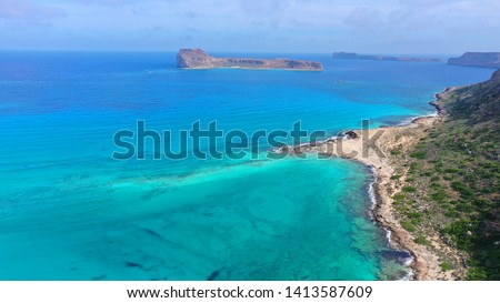 Aerial drone photo of iconic small island of Gramvousa as seen from deep turquoise Balos lagoon in North West Crete island, Greece