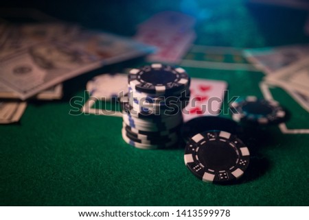 Cards and chips on green felt casino table. Abstract background with copy space. Gambling, poker, casino and cards games theme. Casino elements on green. Selective focus