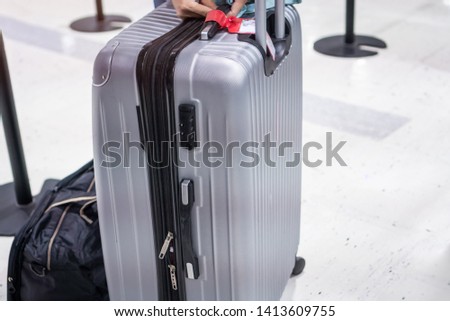 Sillver Suitcases or baggage holder tag blank at front airport departure lounge, Traveler luggage terminal waiting area. Transport Travel insurance concept