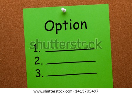 Option list on green paper sheet pinned on cork board. Business concept.