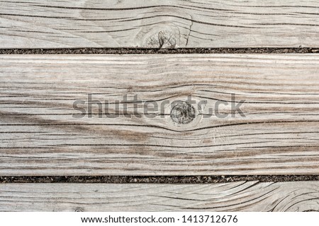 texture of an ancient wooden wall, old dried wood with a lot of cracks and peeling fibers, close-up abstract background