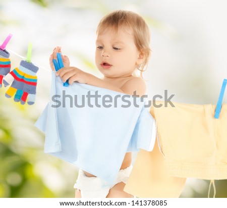 bright picture of adorable baby doing laundry