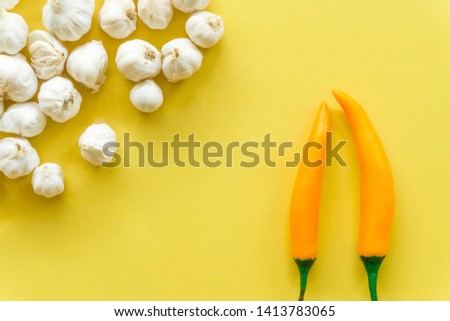 Fresh garlic isolated and 
paprika  on a yellow background, empty space