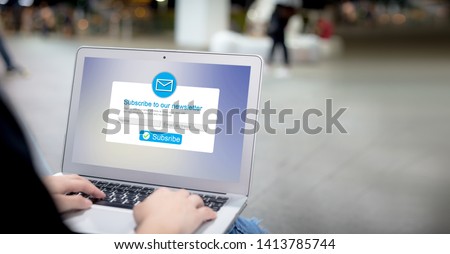 Email marketing subscribe our newsletter concept.Female hands using laptop with copyspace