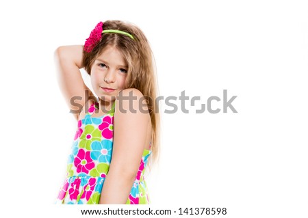 Happy funny little girl in summer colorful dress smiling copyspace isolated on white background