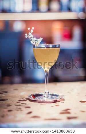 Minimalistic cocktail in glass groceries on bar background