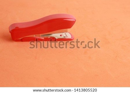 red stapler in color background