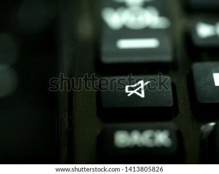Mute button in remote control. The mute switch or button on an electronic audio mixer which silences a channel. Also means silent, quiet, no sound, speech disorder, voiceless, hush. Royalty-Free Stock Photo #1413805826