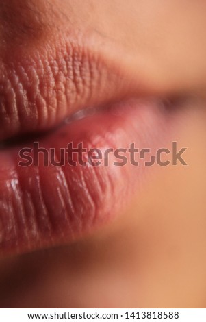 Macro photography of female lips with no edits . Raw and natural lips. No or very small amount of lipstick is used . you can see the countours of dry lips very clearly 