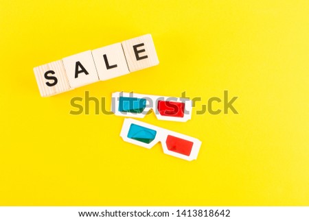 top view of 3d glasses and sale lettering on wooden blocks on yellow background