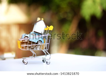 Carts and coins  Small houses and toy cars Concept of selling natural backgrounds