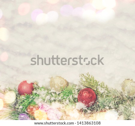 Christmas background with balls and decorations on white snow background. Christmas tree branches with golden and red baubles on white snow. Top view, flat lay